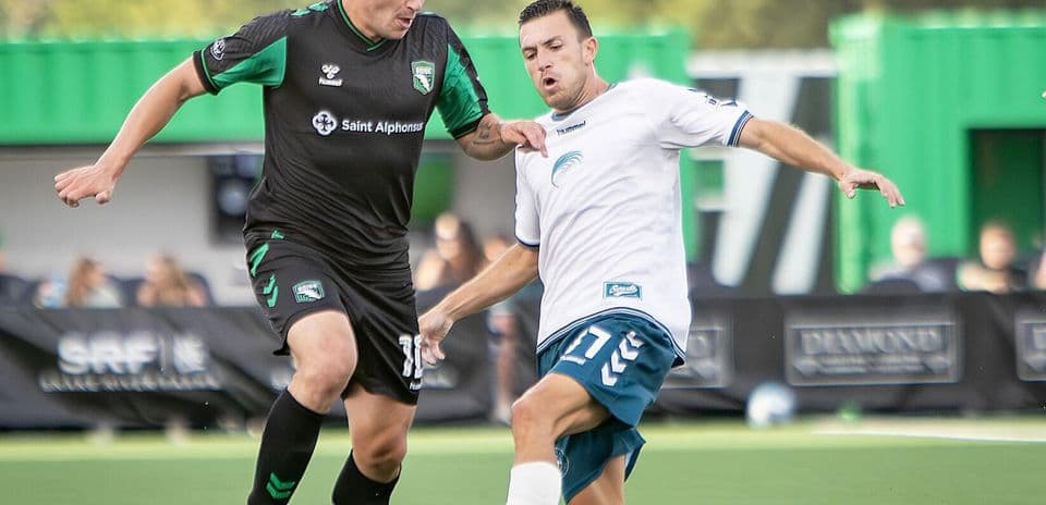 Jugadores compitiendo por el balón en el partido