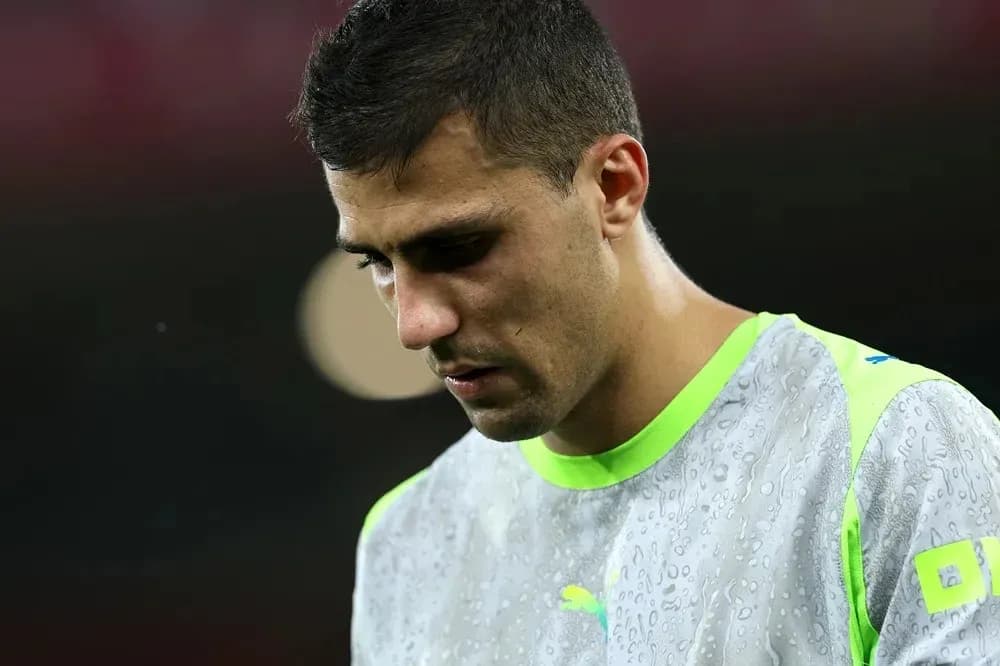 Jugador con uniforme de calentamiento, mirando hacia abajo