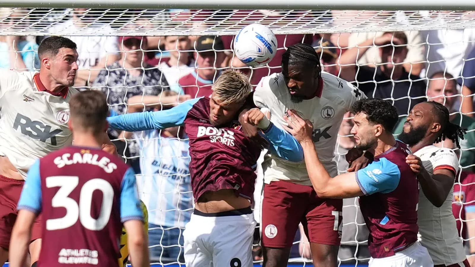 Jugadores luchando por el balón en el área de gol