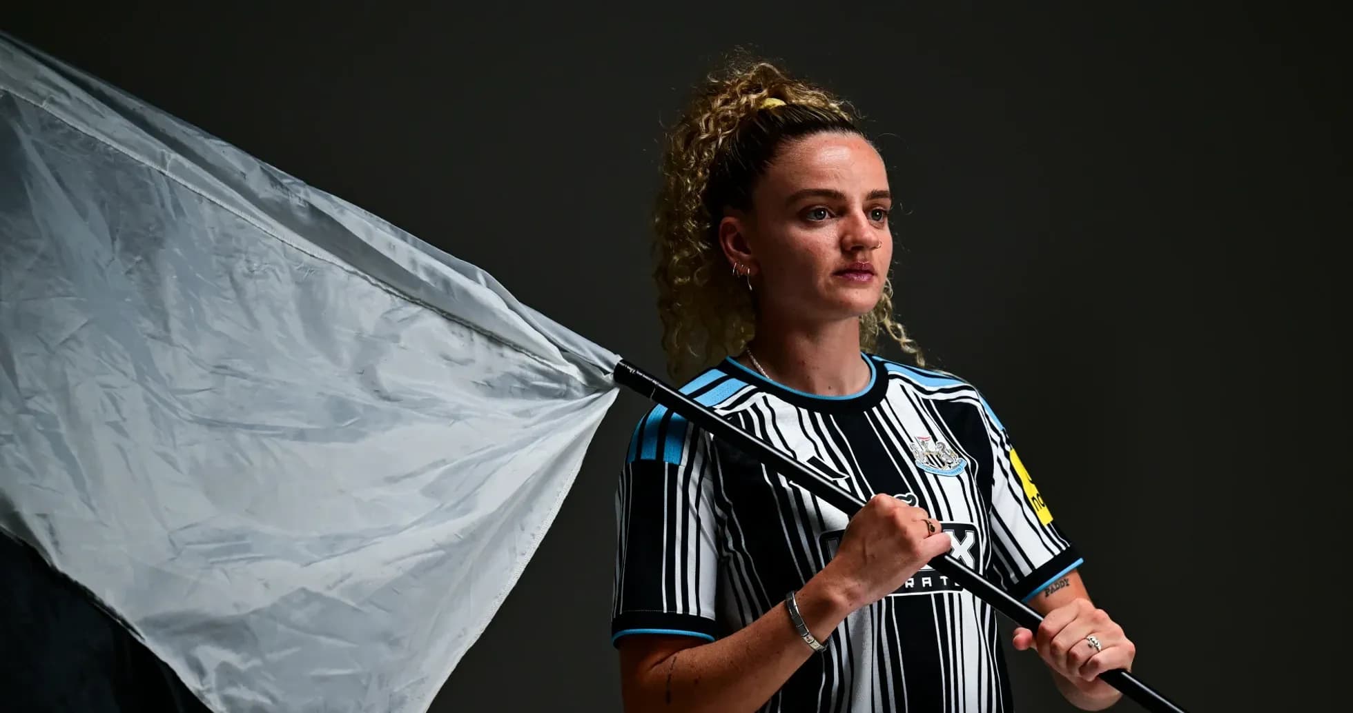 Jugadora sosteniendo una bandera en un estudio