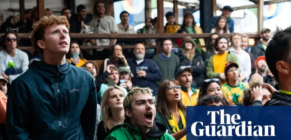 A crowd watching a sports event with intense focus