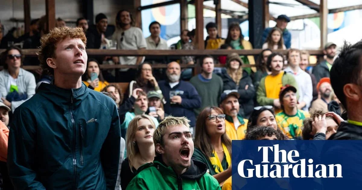 A crowd watching a sports event with intense focus