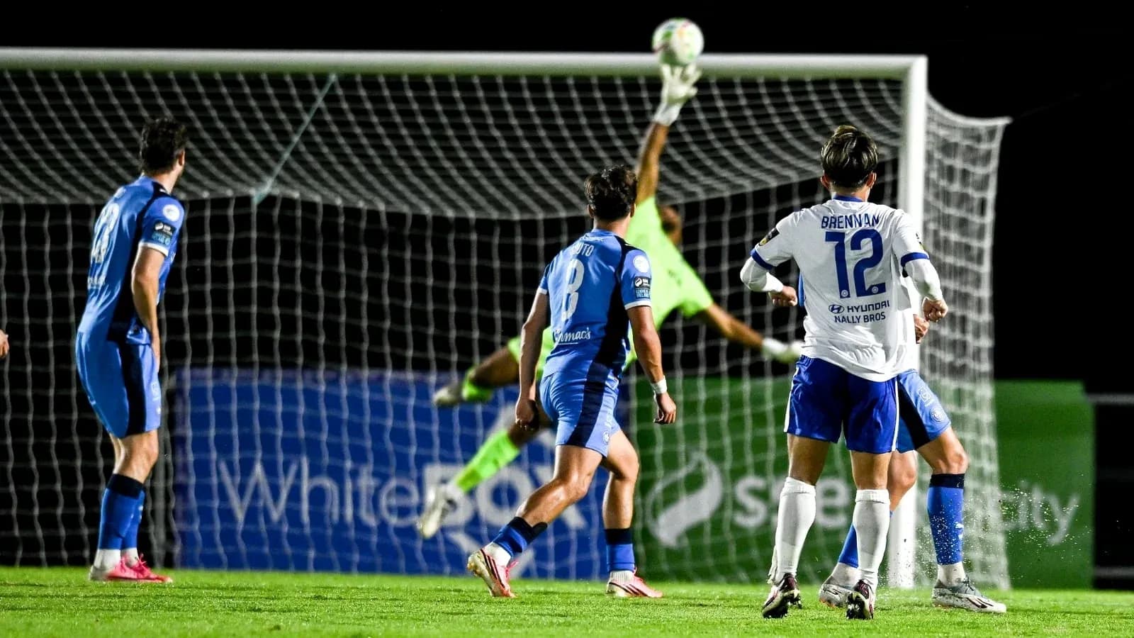 Portero atajando un tiro en el área de gol