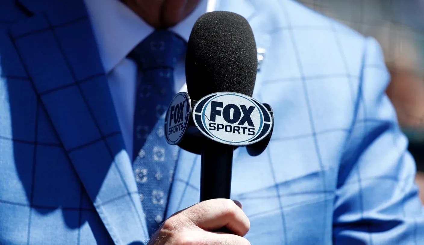 Mic with FOX Sports logo held by reporter