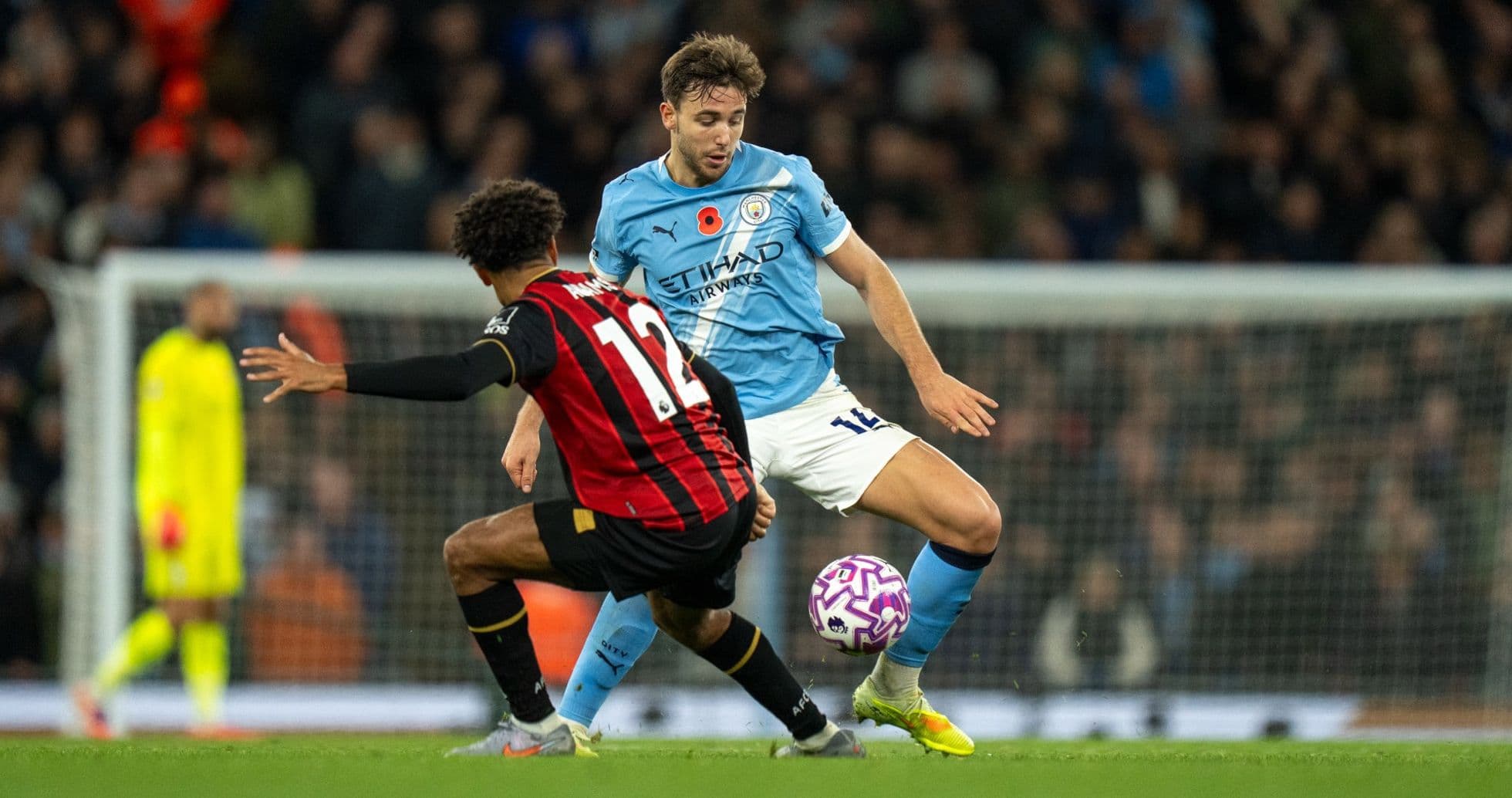 Jugador de Bournemouth desafiando a jugador de Manchester City