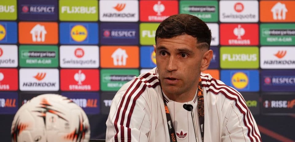 Jugador hablando en conferencia de prensa con balón