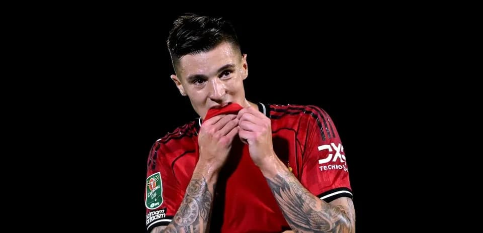 Jugador de fútbol sosteniendo su camiseta roja