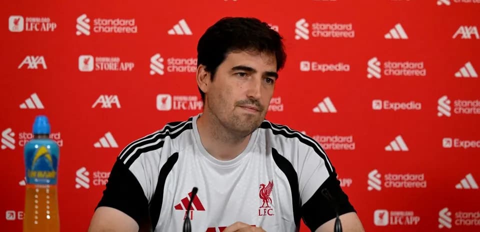 Entrenador en conferencia de prensa con fondo rojo