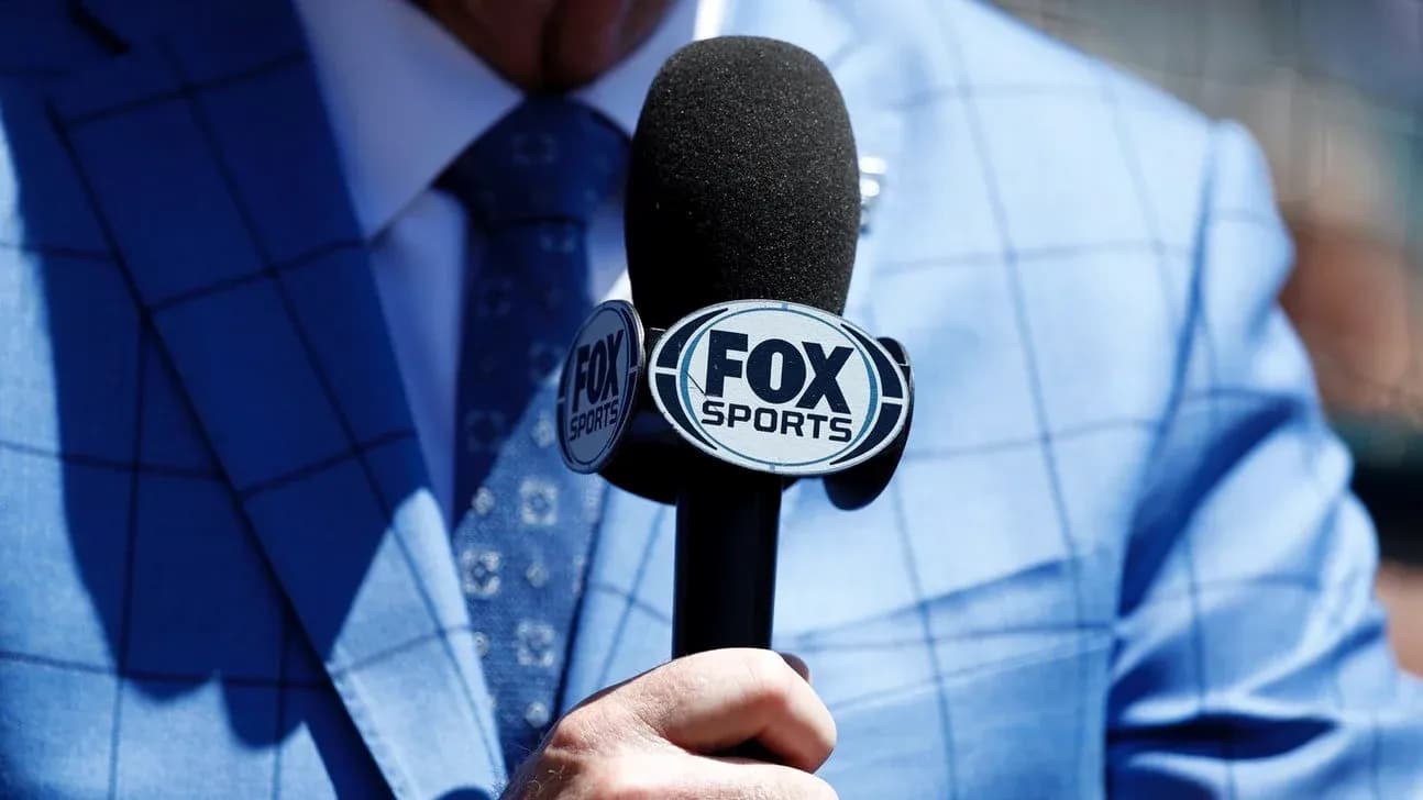 Mic with FOX Sports logo held by person