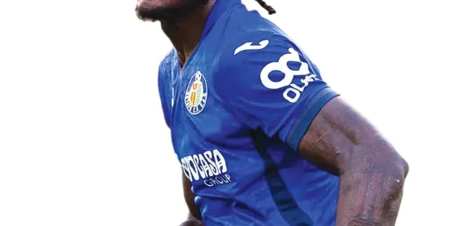 Jugador de fútbol con camiseta azul celebrando una jugada