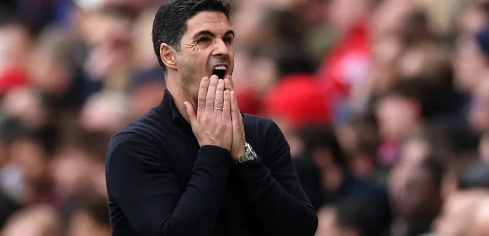 Entrenador gesticulando durante un partido de fútbol
