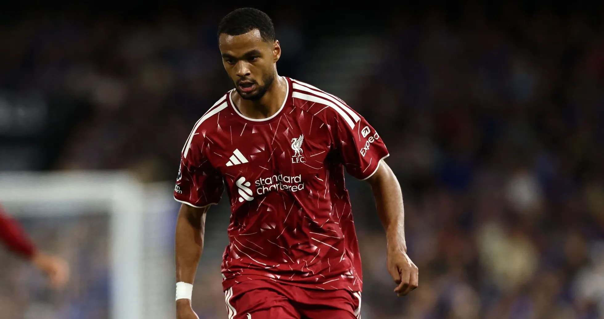 Jugador de Liverpool corriendo con balón en el campo