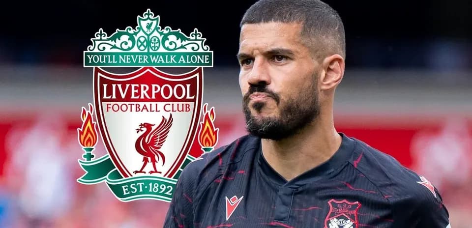 Jugador de fútbol frente al escudo del Liverpool FC