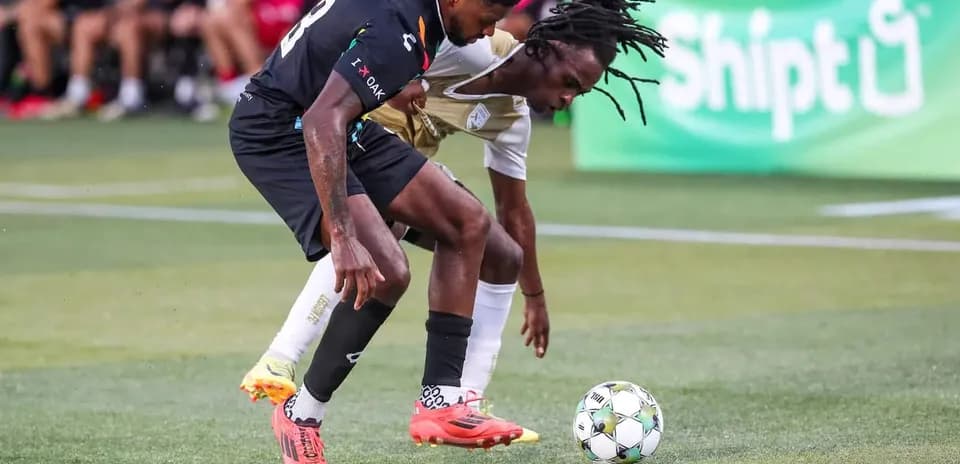 Dos jugadores compitiendo por el balón en el partido