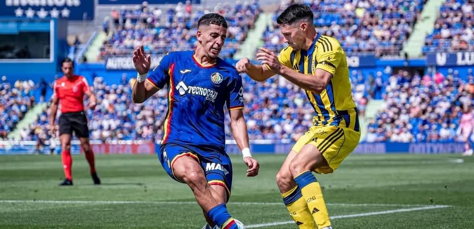 Jugador de Getafe desafiando a un oponente de Oviedo