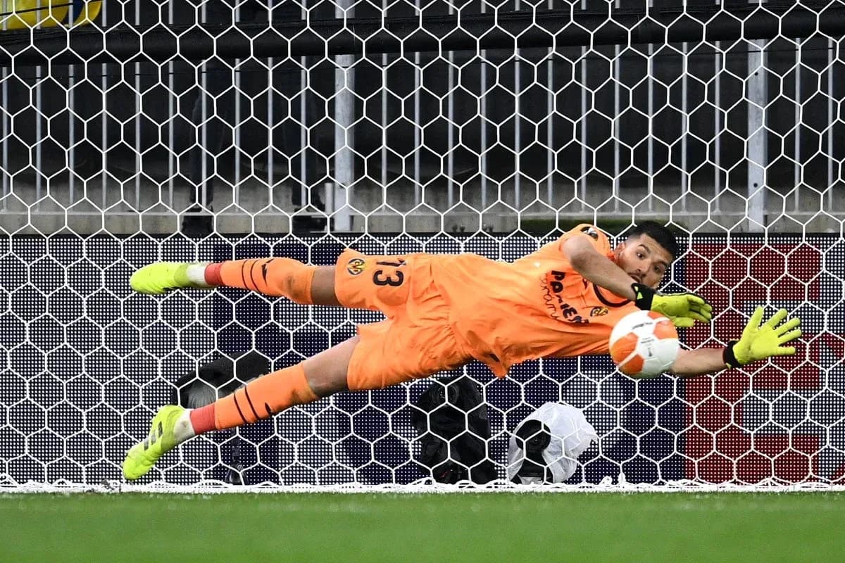 Portero lanzándose para detener un penalti Portero lanzándose para detener un penalti
