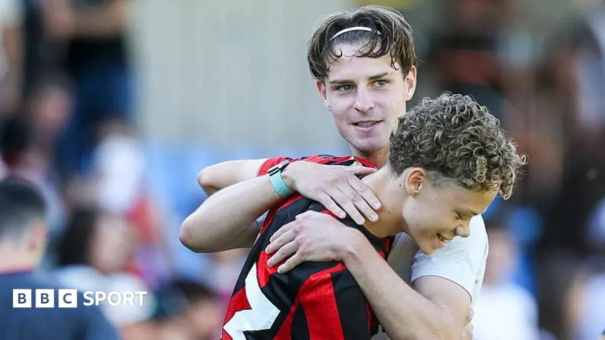 Dos jugadores abrazándose en el campo de fútbol Dos jugadores abrazándose en el campo de fútbol